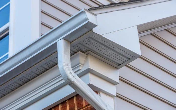 Seamless gutter installation on a residential home